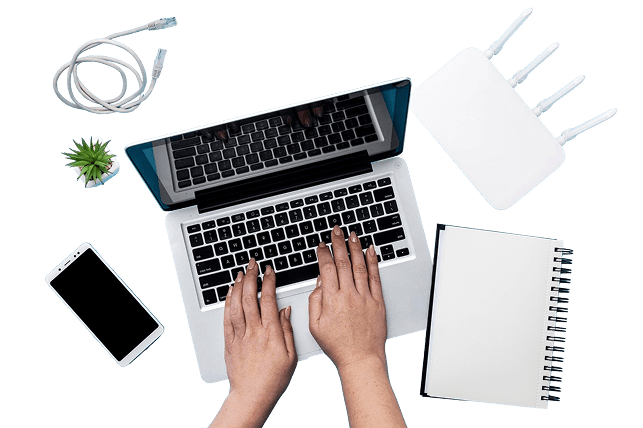 Person working on laptop with broadband router on desk